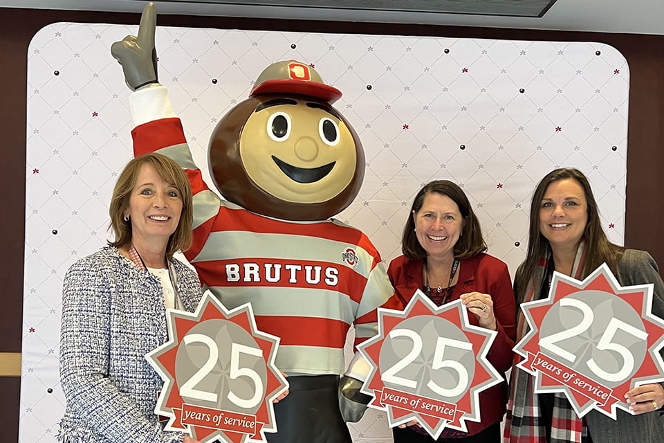 Kirsten Gibbons, the Department Administrator for CATALYST; Ann Scheck McAlearney, ScD, MS, the Executive Director of CATALYST; and Alice Gaughan, MS, the Associate Director of CATALYST, pose with a Brutus statue at a celebration marking their 25 years of service with Ohio State.