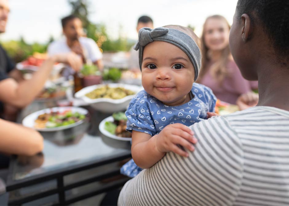 Mother and her child with a group of friends at an outdoor cafe