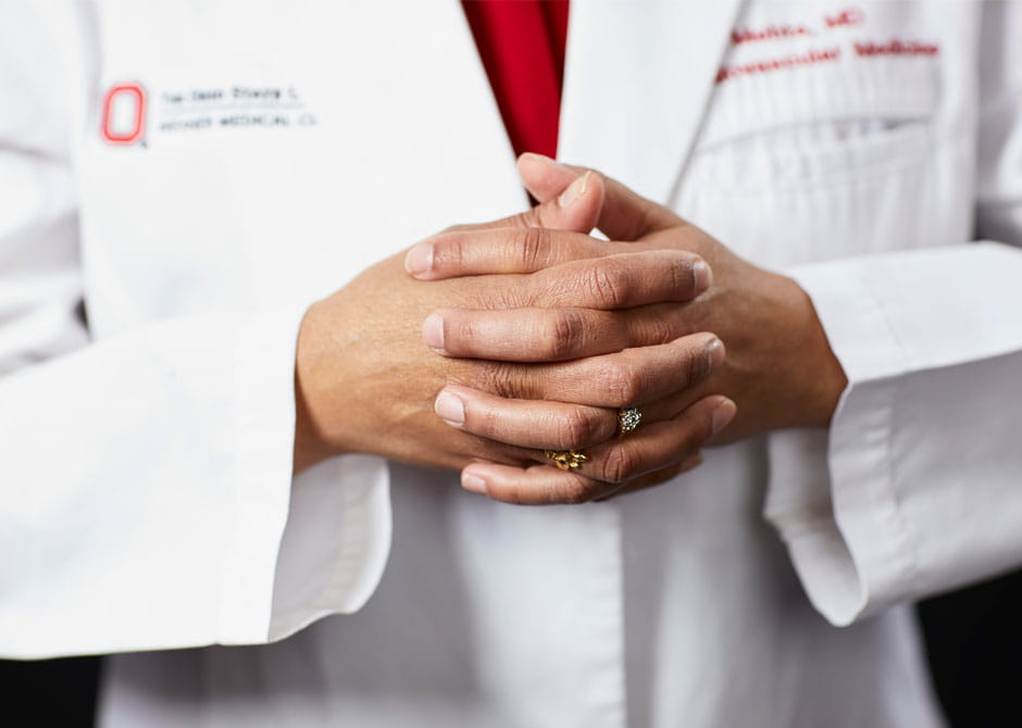Doctor's hands in front of white, Ohio State University Wexner Medical Center lab coat