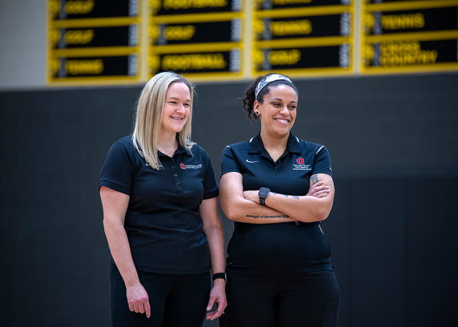 two athletic trainers smiling