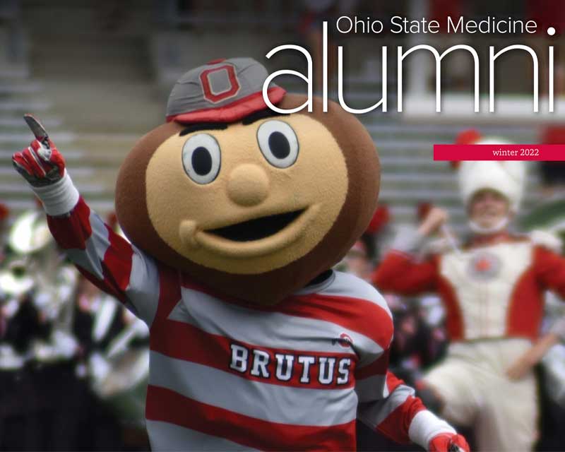 Alumni newsletter winter 2022 Brutus Buckeye in front of marching band