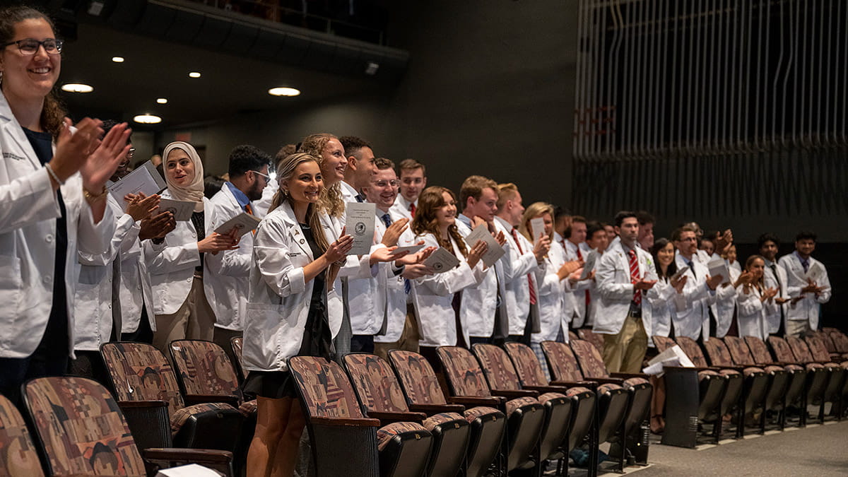 People clapping during a White Coat ceremony