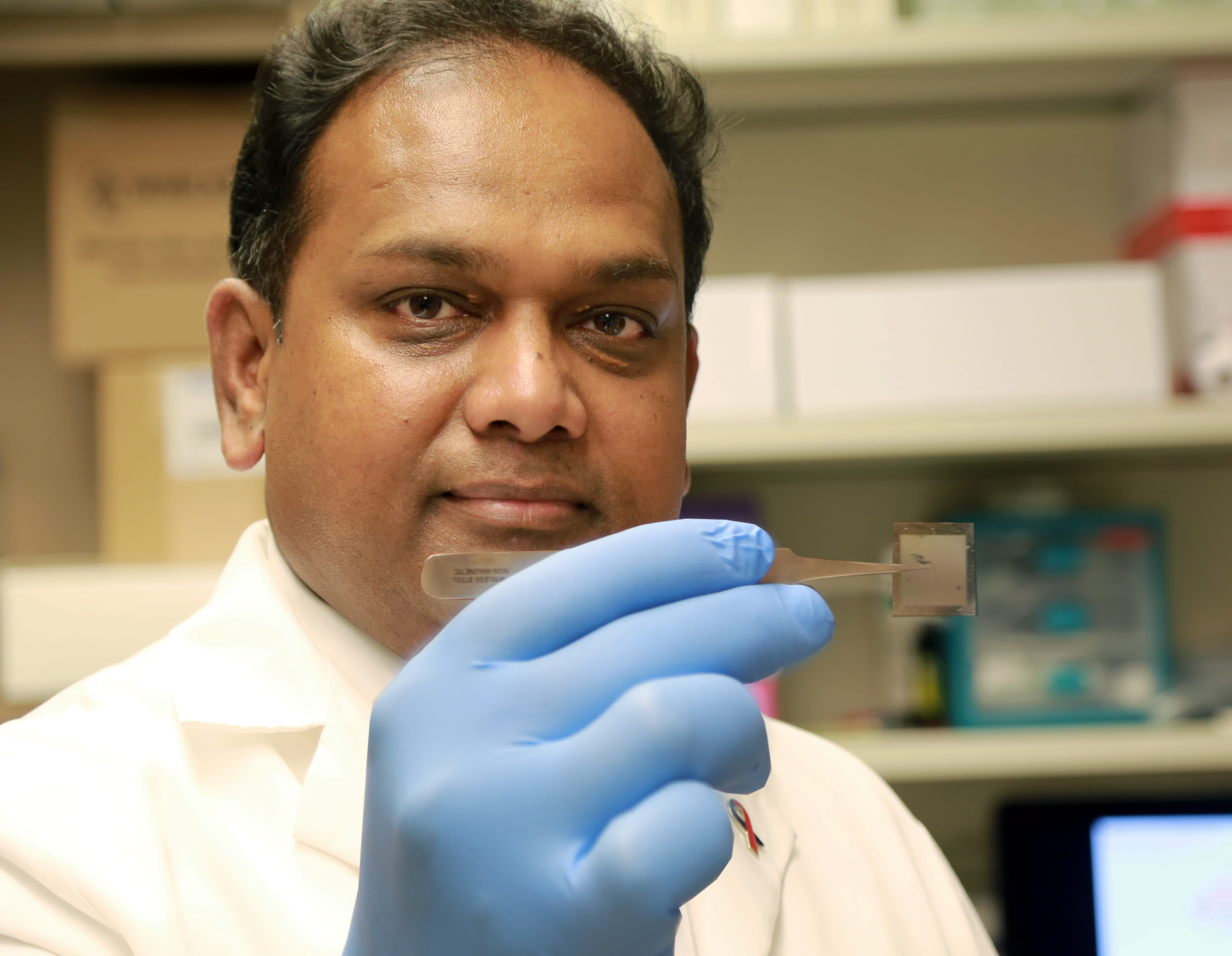 Dr. Chandan Sen holds the TNT nanochip