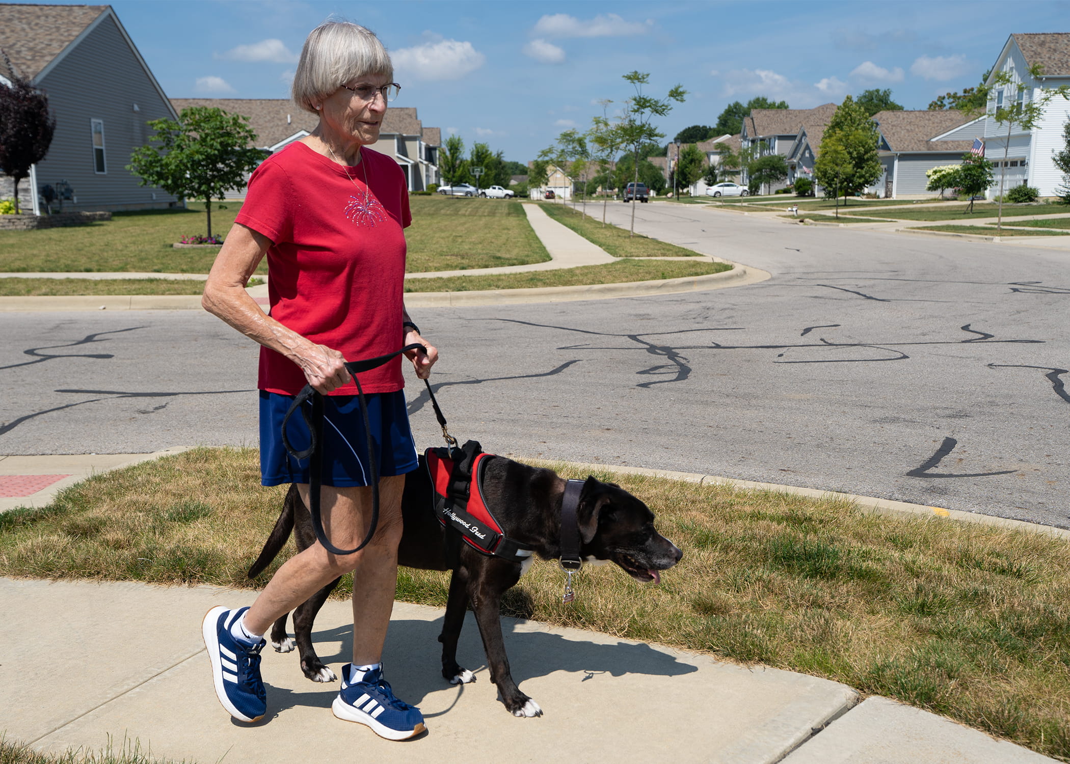 Linda Barber walks her dog as part of her routine to maintain her brain health. She has been diagnosed with early Alzheimer's disease. 