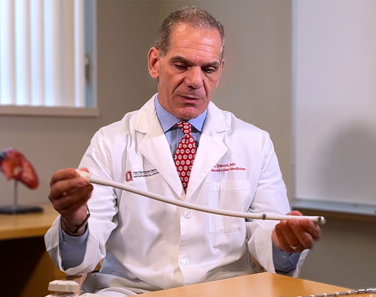 Dr. Emile Daoud demonstrates a device that gently moves the esophagus during heart ablations. 