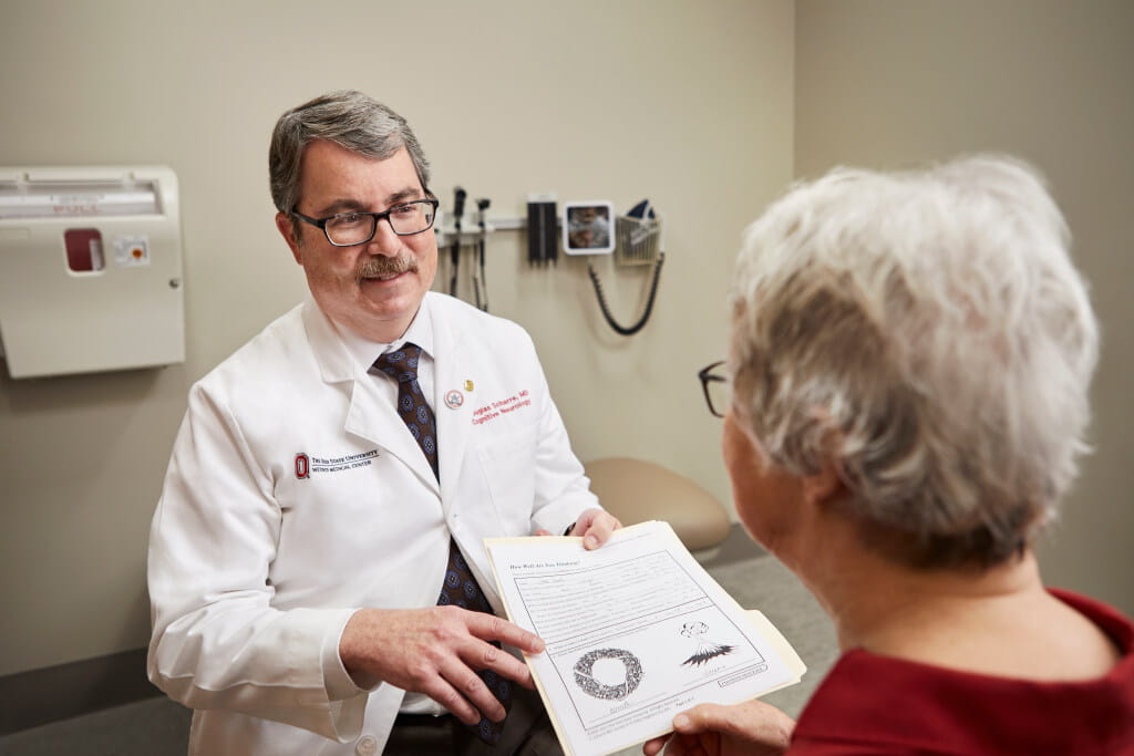 Douglas Scharre, MD, director of the division of cognitive neurology at Ohio State Wexner Medical Center, shows the SAGE test to a patient.