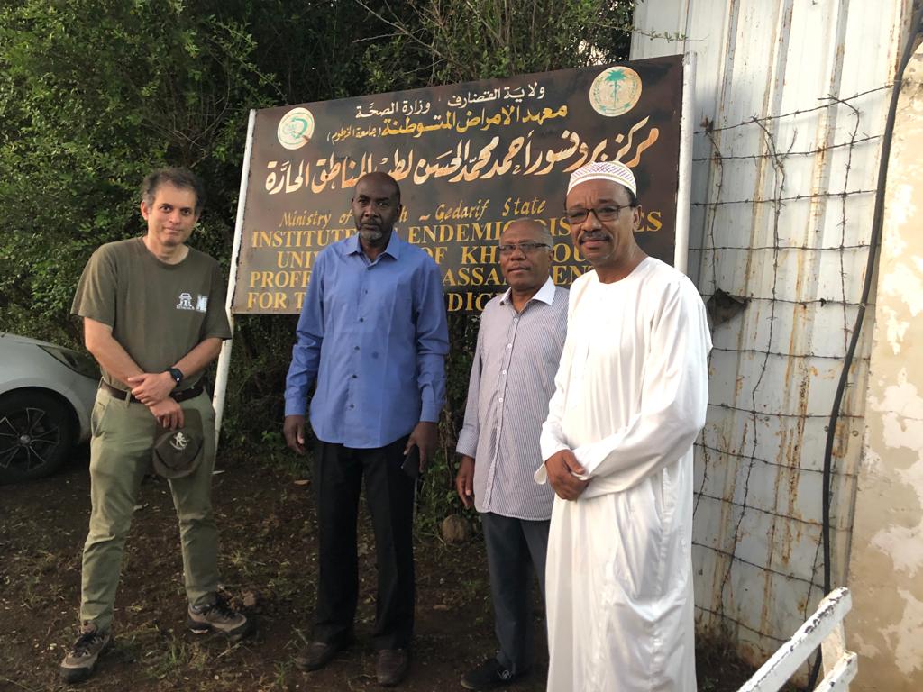 Abhay Satoskar, MD, PhD, (far left) poses with fellow health officials at the Gedaref State Ministry of Health in Sudan, which funds research and specialized care for endemic diseases.