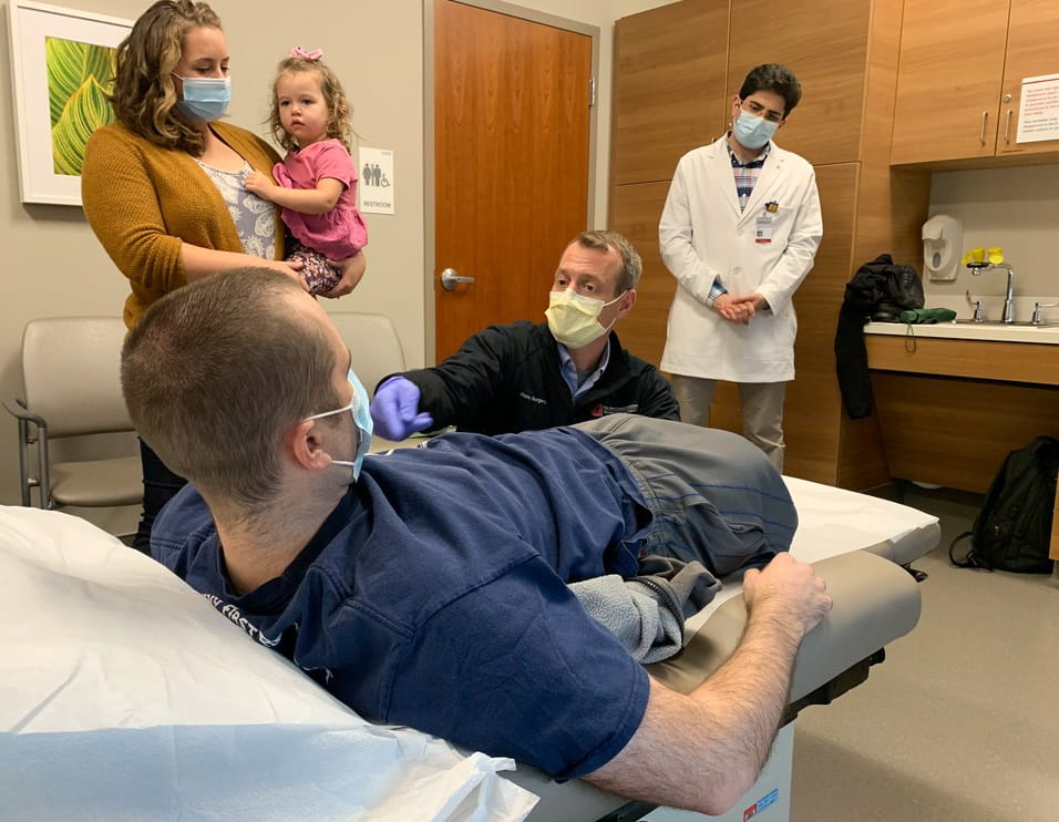 Dr. Jason Souza examines Nick Vogt at The Ohio State University Wexner Medical Center to assess his recovery after surgery. 