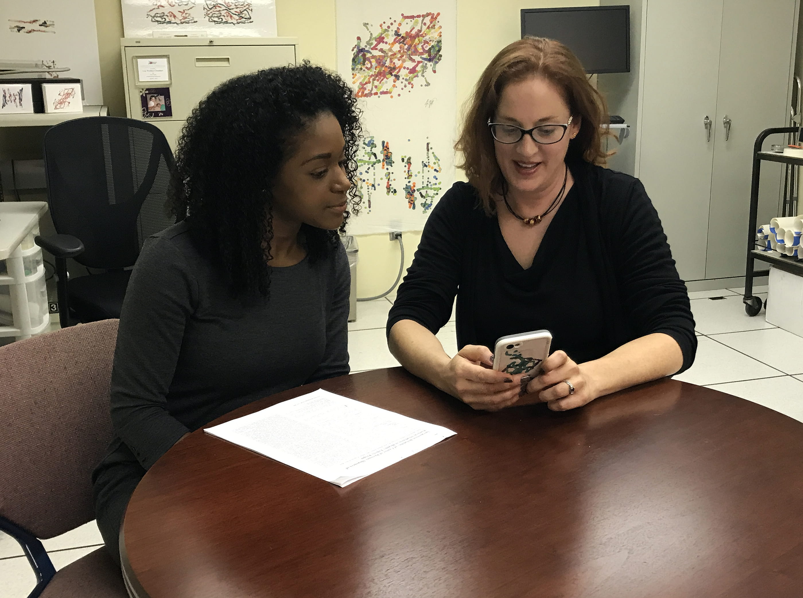 Researcher Lise Worthen-Chaudhari (right) tests out the SuperBetter app at The Ohio State University Wexner Medical Center with colleague, Courtney Bland. 