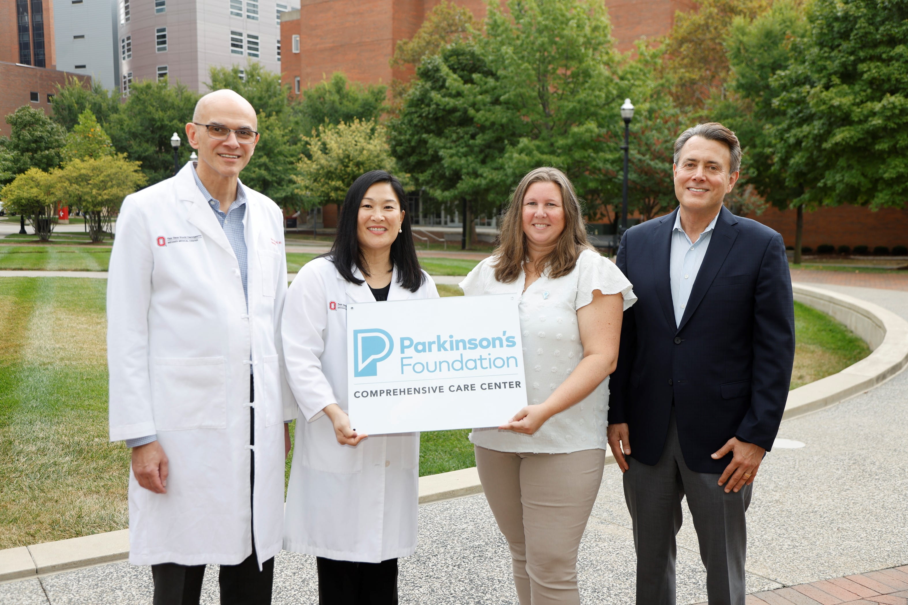 Caption for the photo: (left to right): Pietro Mazzoni, MD, co-director of Division of Parkinson’s Disease and Other Movement Disorders; Ariane Park, MD, co-director of Division of Parkinson’s Disease and Other Movement Disorders; Laura Summers, Community Program Manager, Parkinson's Foundation; Benjamin Segal, MD, chair of the Department of Neurology and Co-director of the Neurological Institute. 