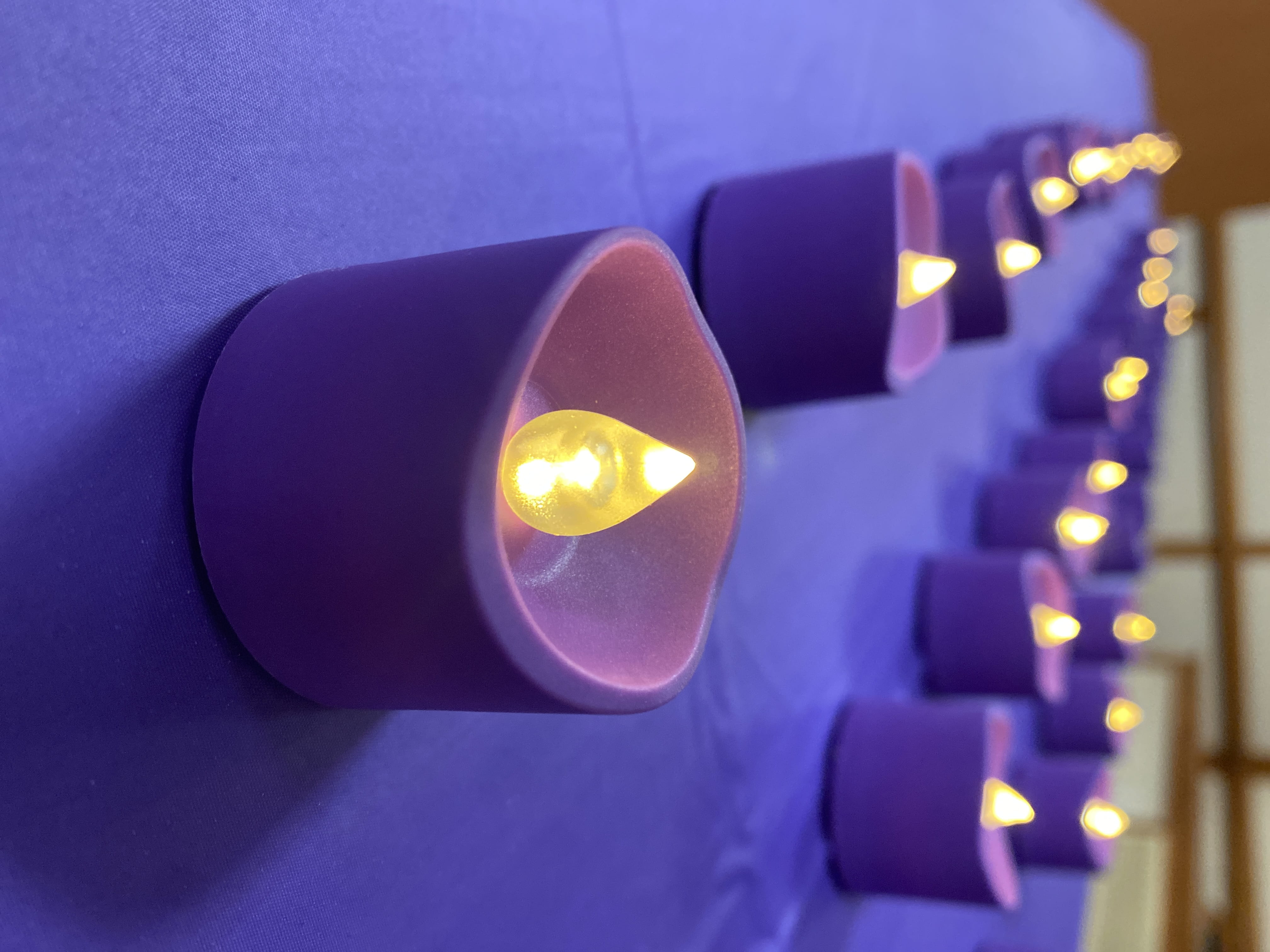 Purple tealights are lit at a remembrance event for those lost to overdose