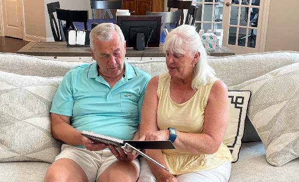 Frank Rupnik looks at family photos with his wife, Nancy, in their Delaware, Ohio home. Frank was diagnosed with early-stage Alzheimer’s disease and takes the digital Brain Test on a tablet every six months that informs his neurologist about any changes in cognition or needed adjustments in treatment.