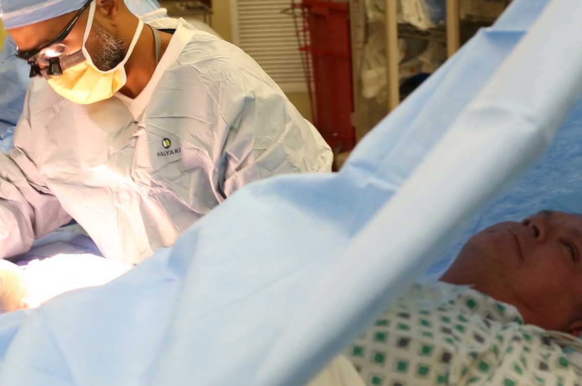 Doctors operating on thumb