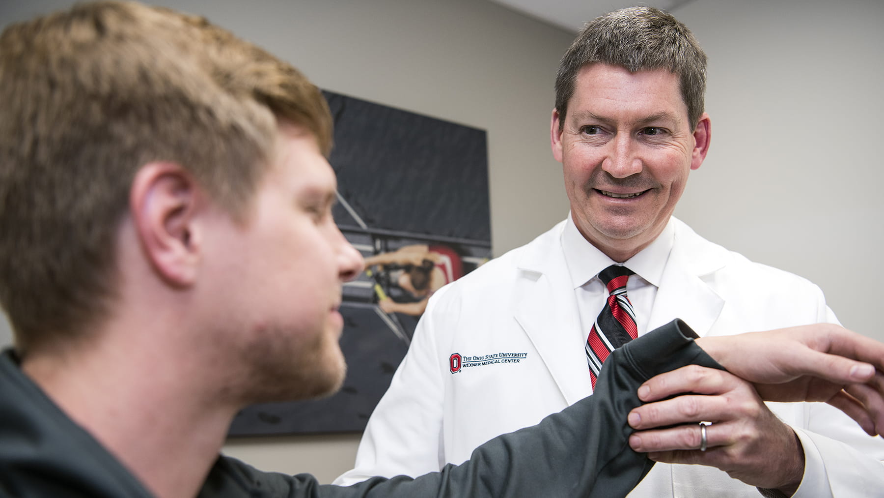 Grant Jones, MD at The Ohio State Sports Medicine Institute examining a man with a shoulder injury