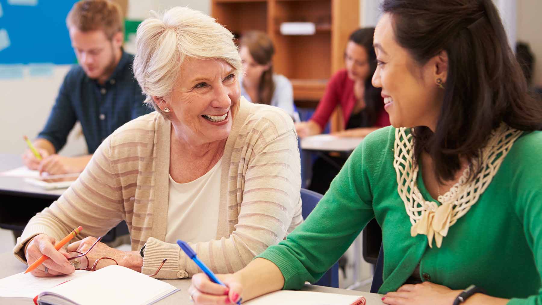 Older woman and younger woman taking a college class together