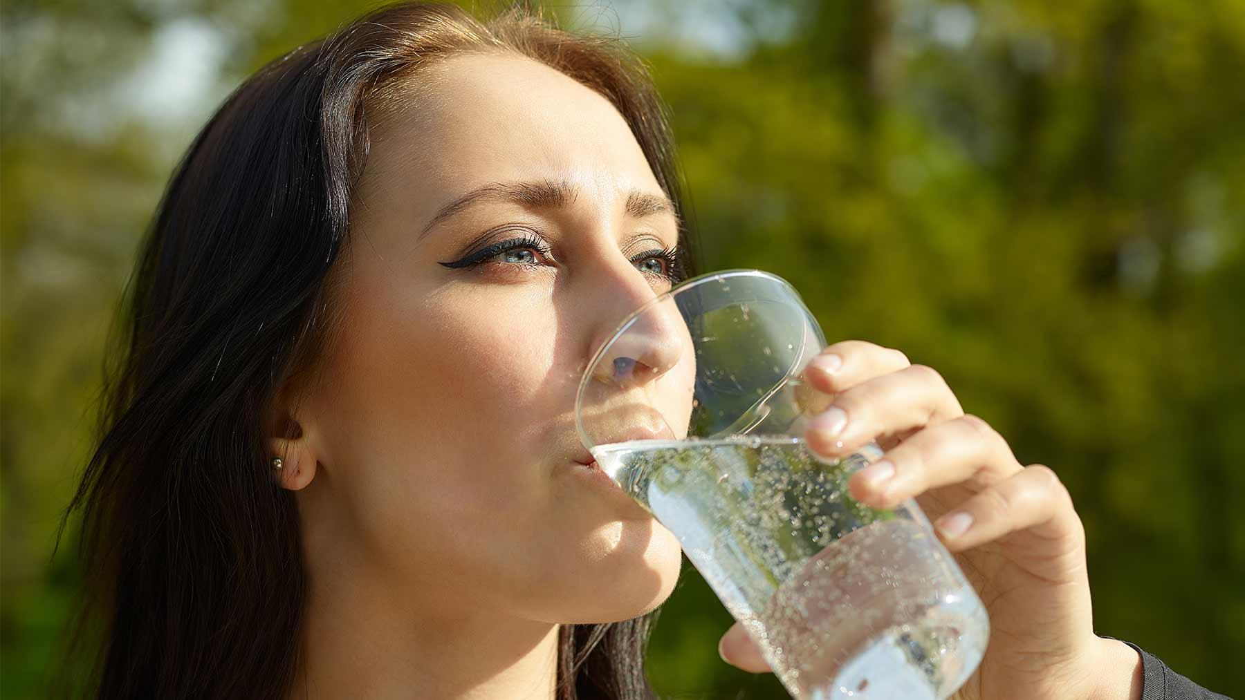 woman drinking sparkling glass of water