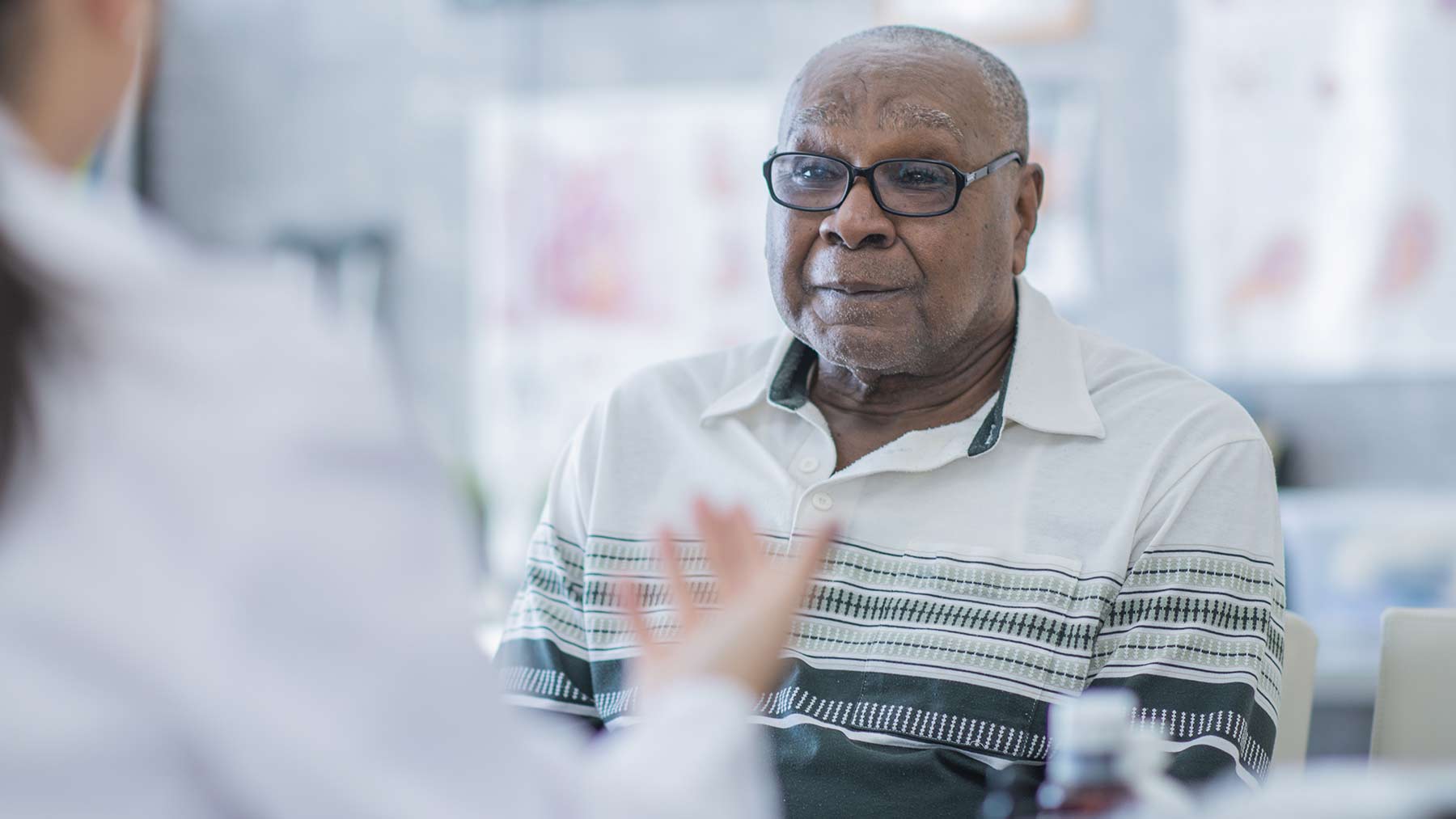 elderly overweight man listening to doctor