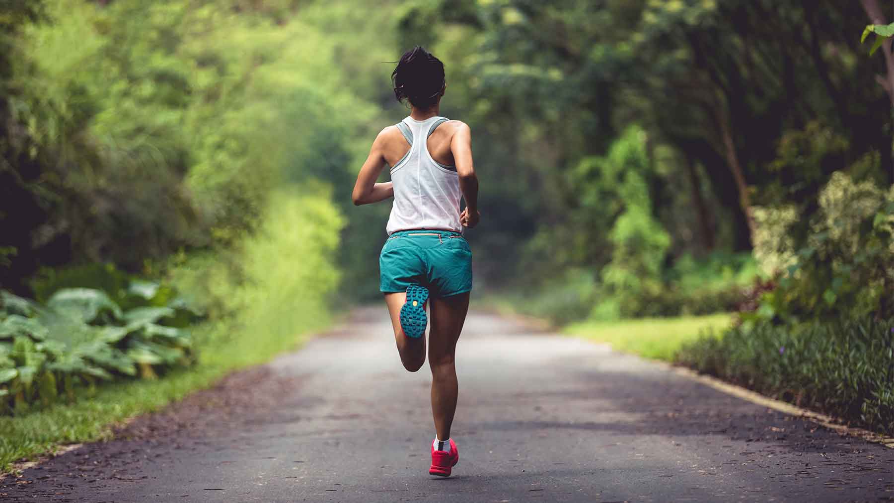 Woman Jogging In City At Night by Microgen Images/science Photo Library