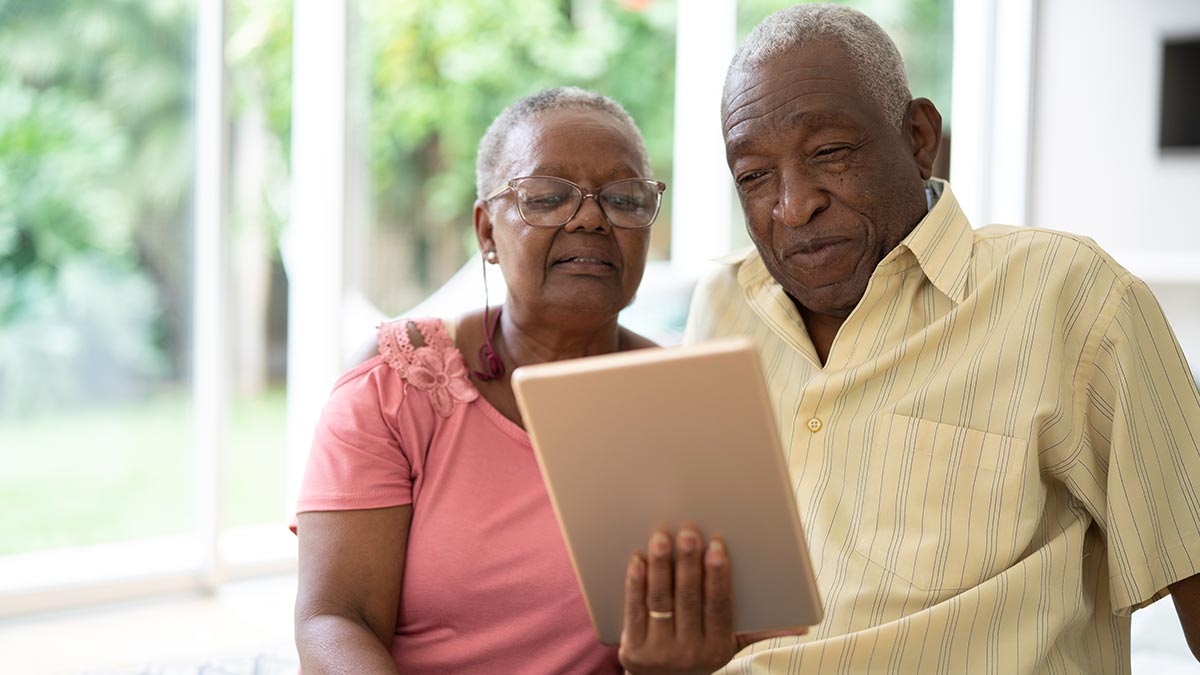 Elderly Black Woman and Black Man using tablet