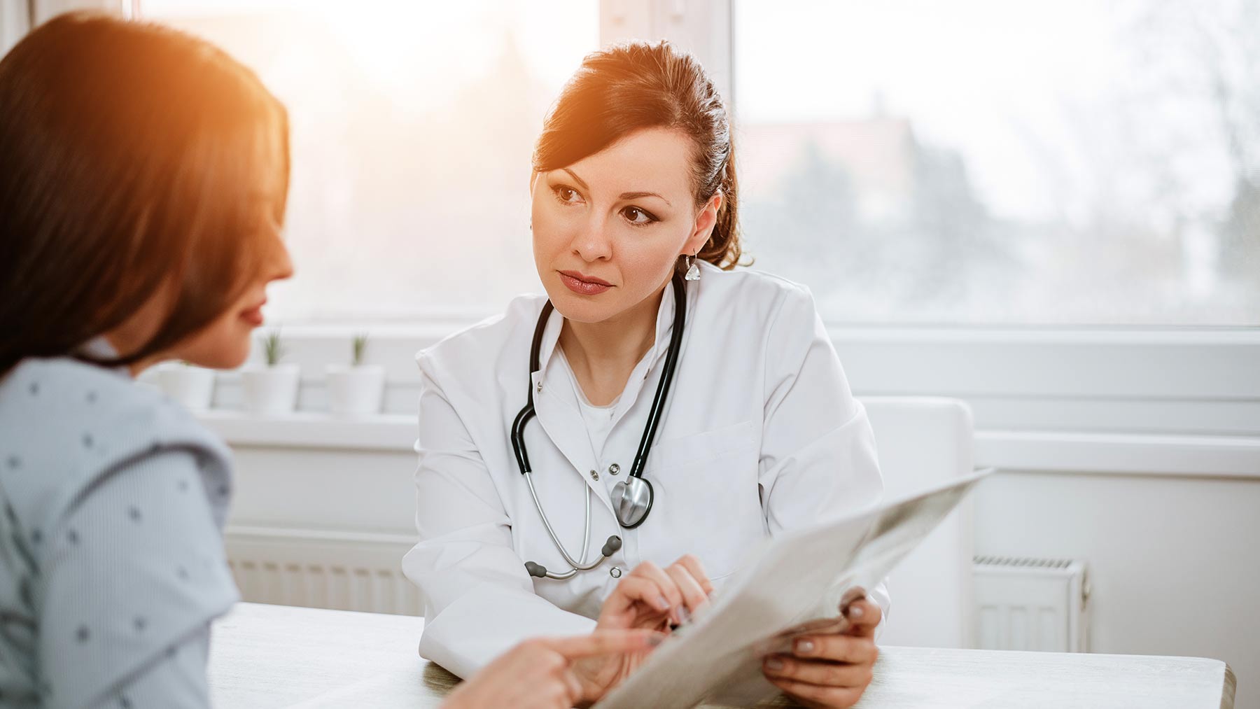 Female physician consulting with female patient