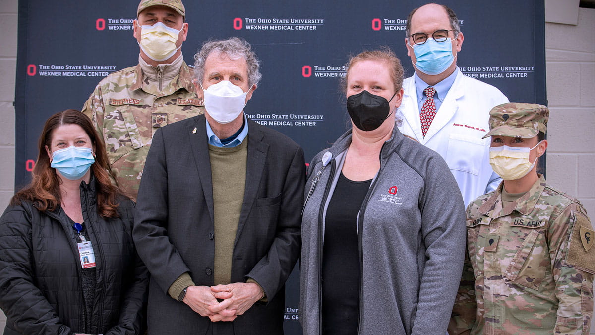 U.S. Sen. Sherrod Brown standing with members from the Ohio National Guard and the Ohio State Wexner Medical Center