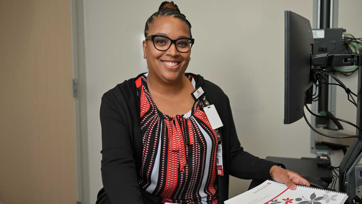 Tiffany Johnson, RN-Care Coordinator sitting at a desk