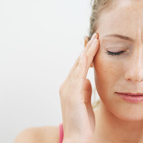 Woman pressing head from sinus pain
