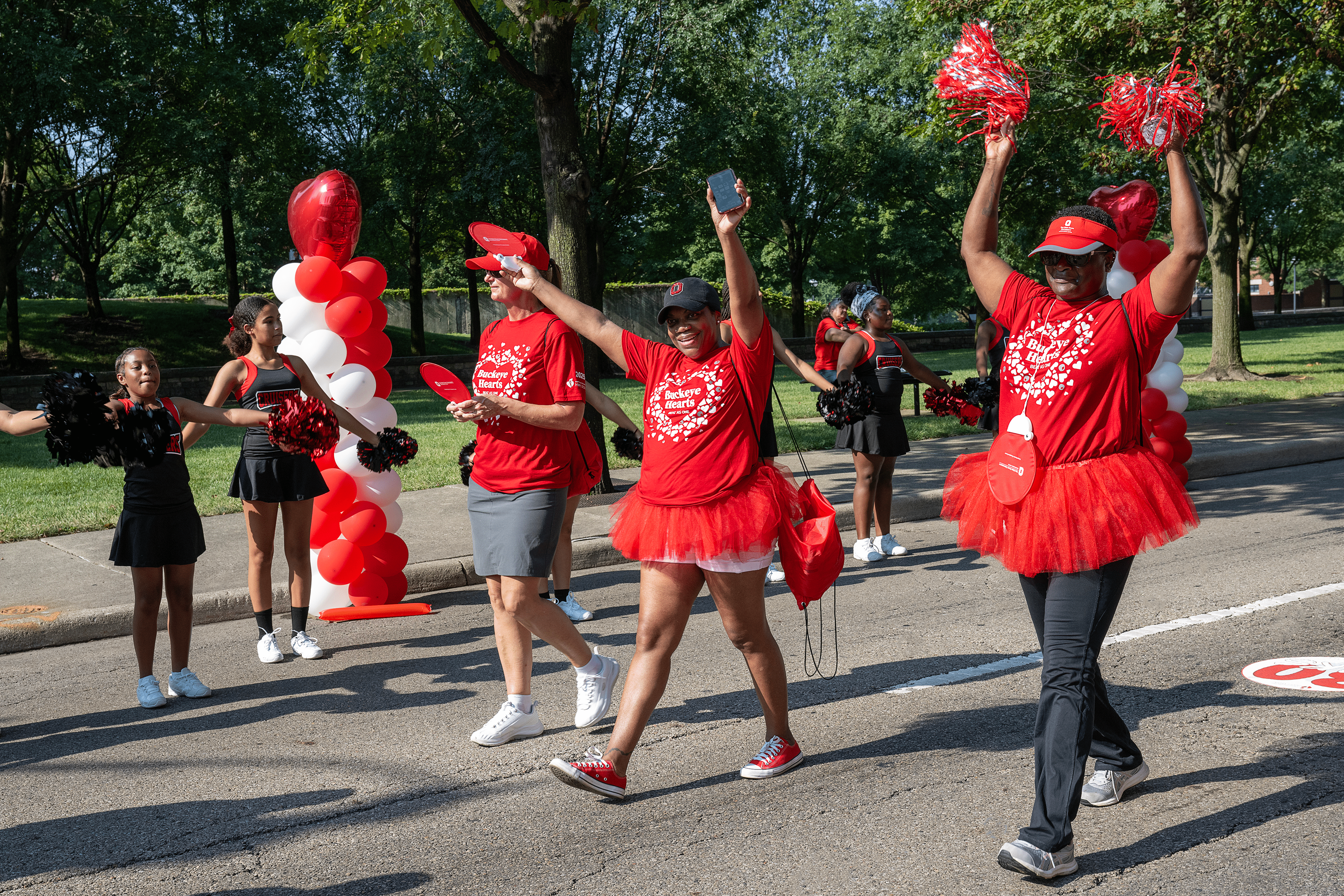 Two female Team Ohio State walkers wearing red tutus and holding red pompoms