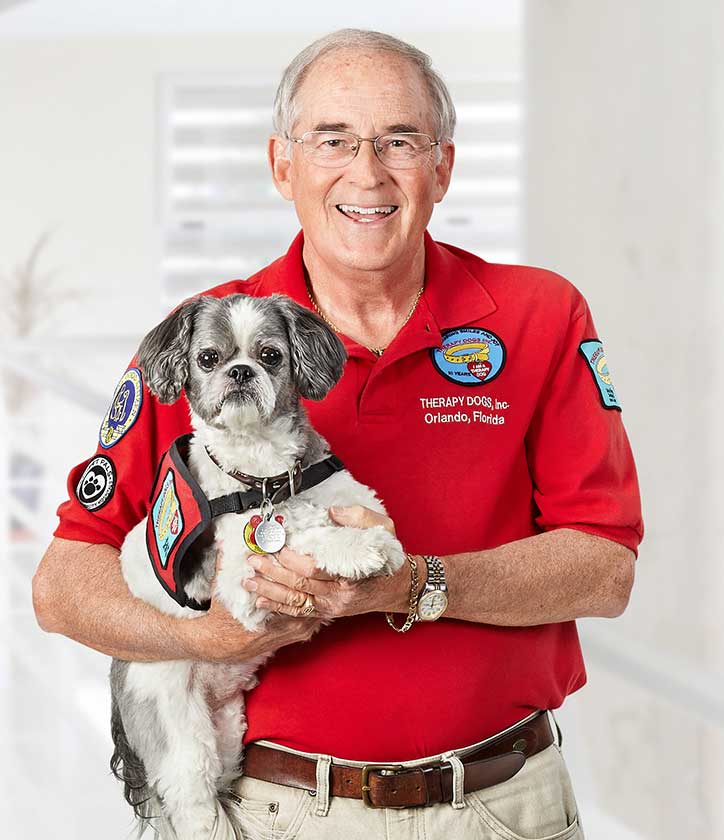 Man holding dog in arms