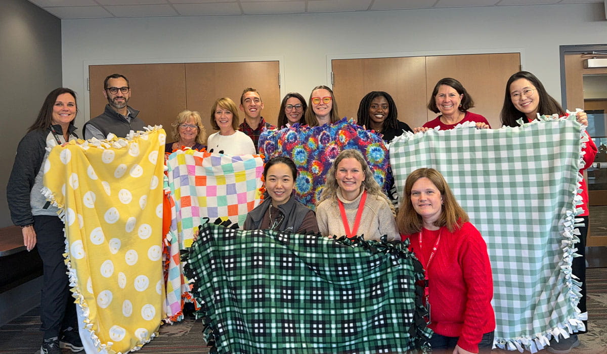 CATALYST team holding up blankets.