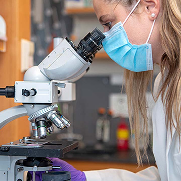 Female Researcher Microscope Close Up