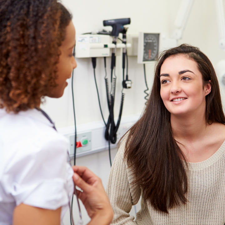 Teen patient in conversation with doctor