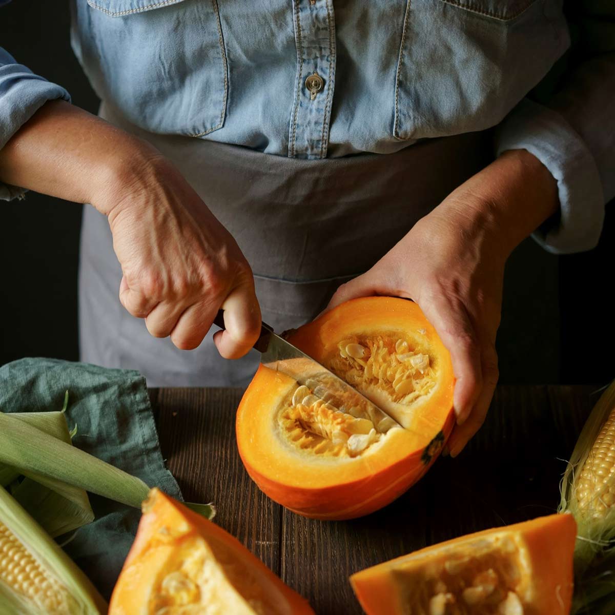 A cook slicing a pumpkin