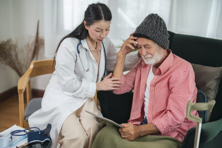An elderly man discusses dementia with a doctor. Dementia means someone is having trouble with memory or thinking to an extent that they need help with performing daily activities. Though it mostly affects older people, it’s not a normal part of aging.