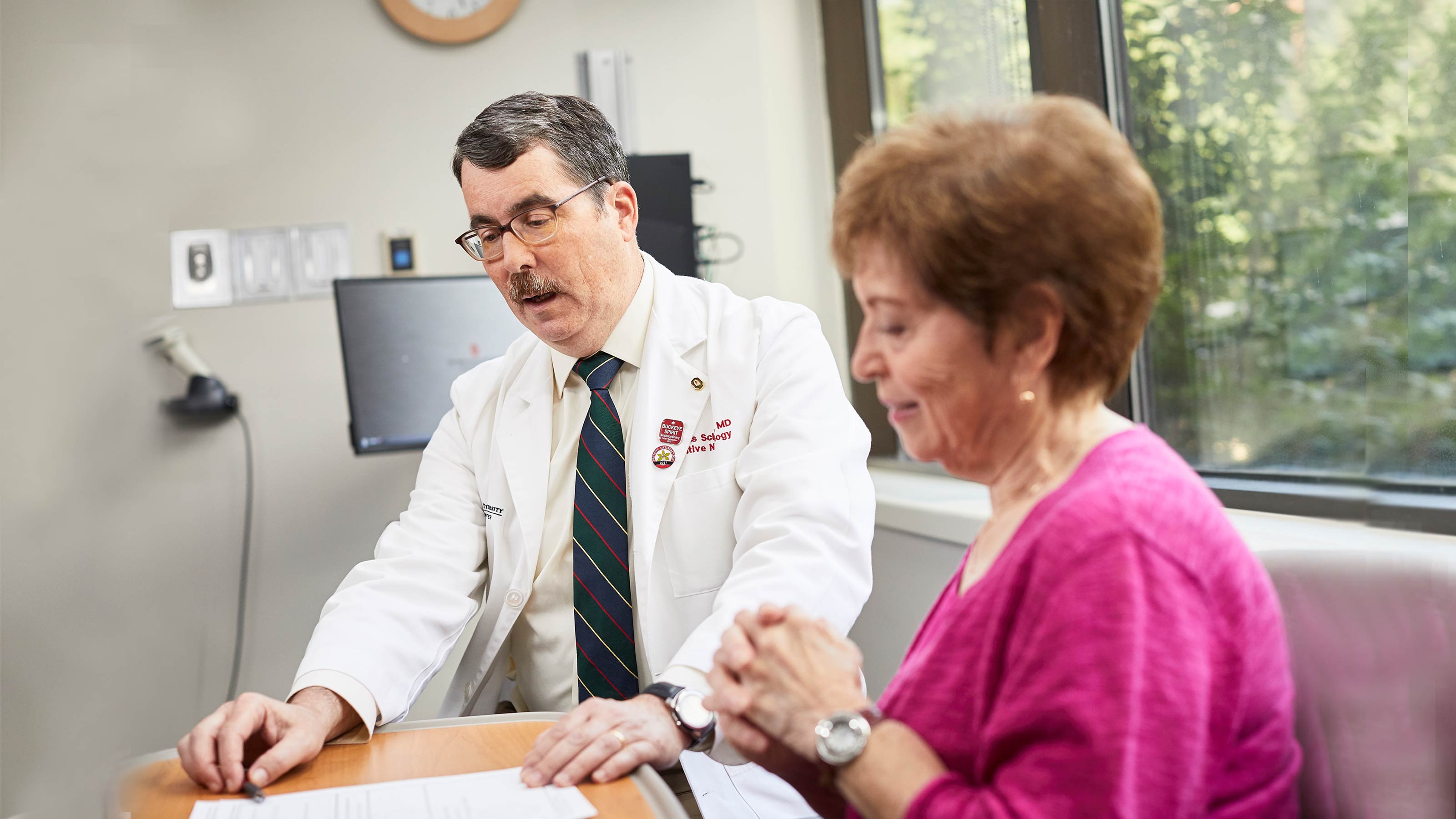 Dr. Scharre with patient reviewing SAGE test to diagnosis Alzheimer's disease