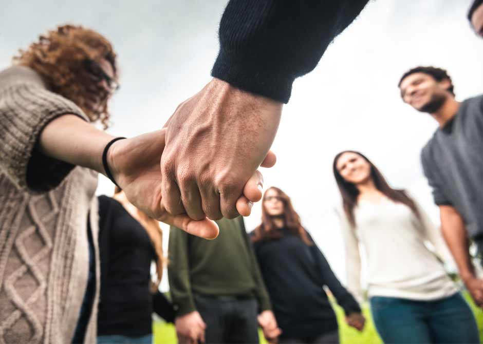 Group outside in circle holding hands