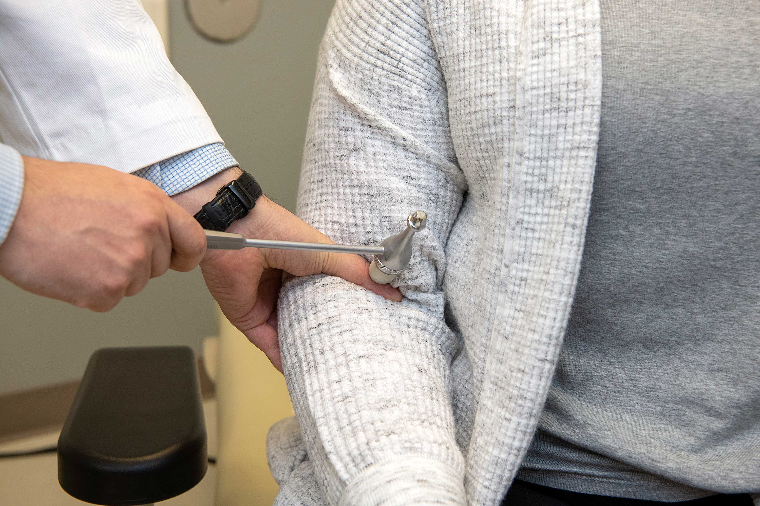 An expert in Parkinson's disease tests the muscle and reflexes of a patient.