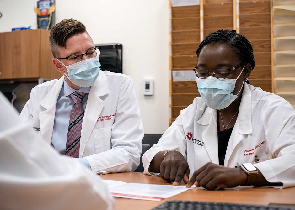 Doctors Harrington and Gyang reviewing documents in an office