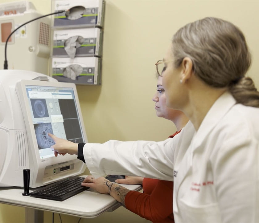 Dr. Cebulla reviewing imaging with with patient.