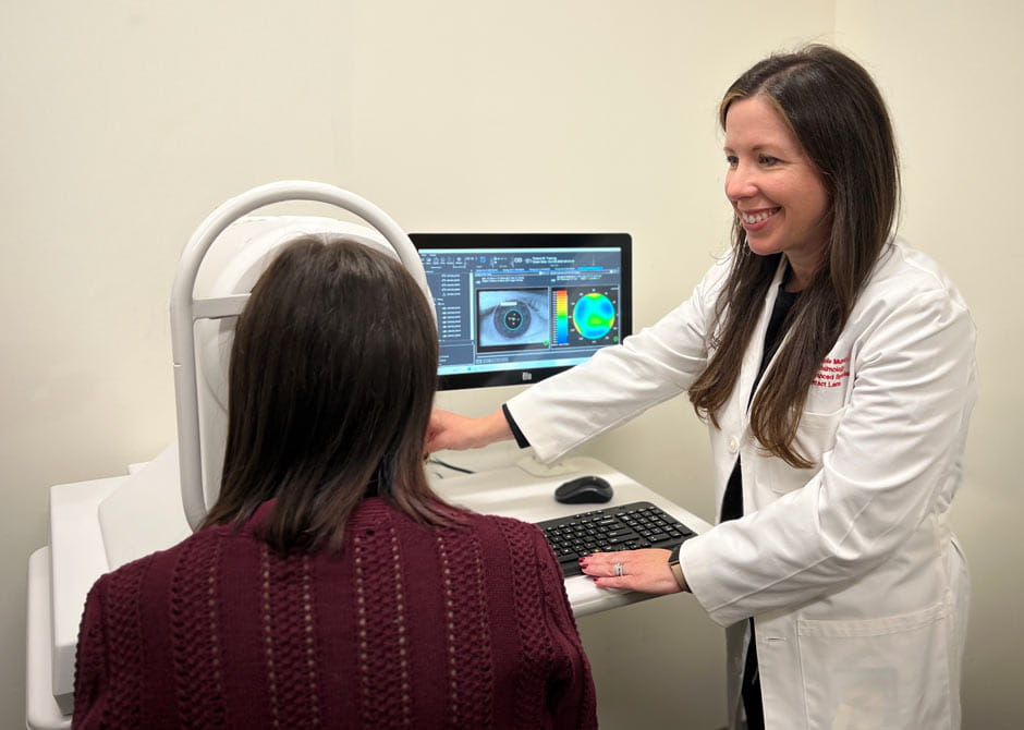 An ophthalmologist examining a patient's eye with a WavDyn Analyzer