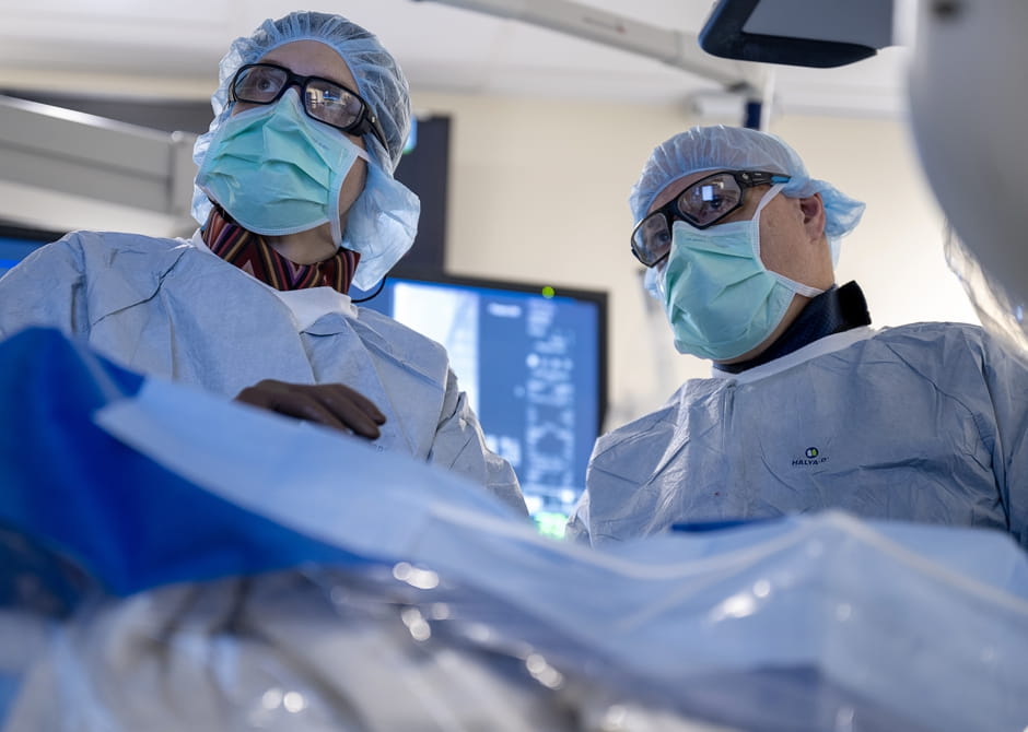 Close-up image of two vascular surgeons in operating room
