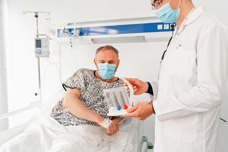 Doctor showing patient breathing device