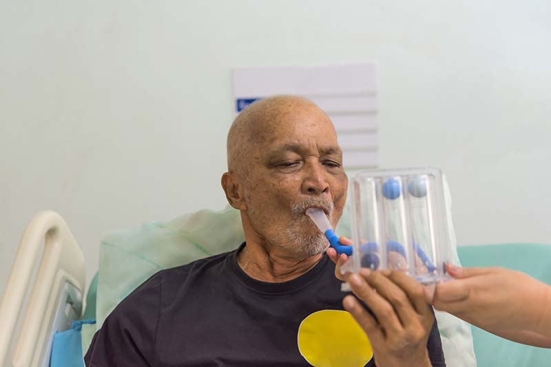 Man using spirometer in hospital