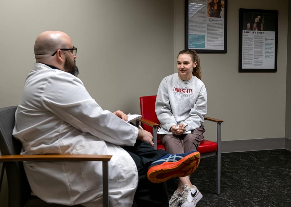 A patient speaking with a counselor at at an inpatient mental health care setting