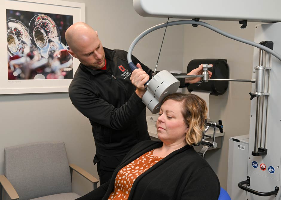 Transcranial Magnetic Stimulation (TMS) being performed on patient by Dr. Kevin Reeve