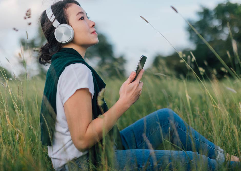 Woman listening to music in a field