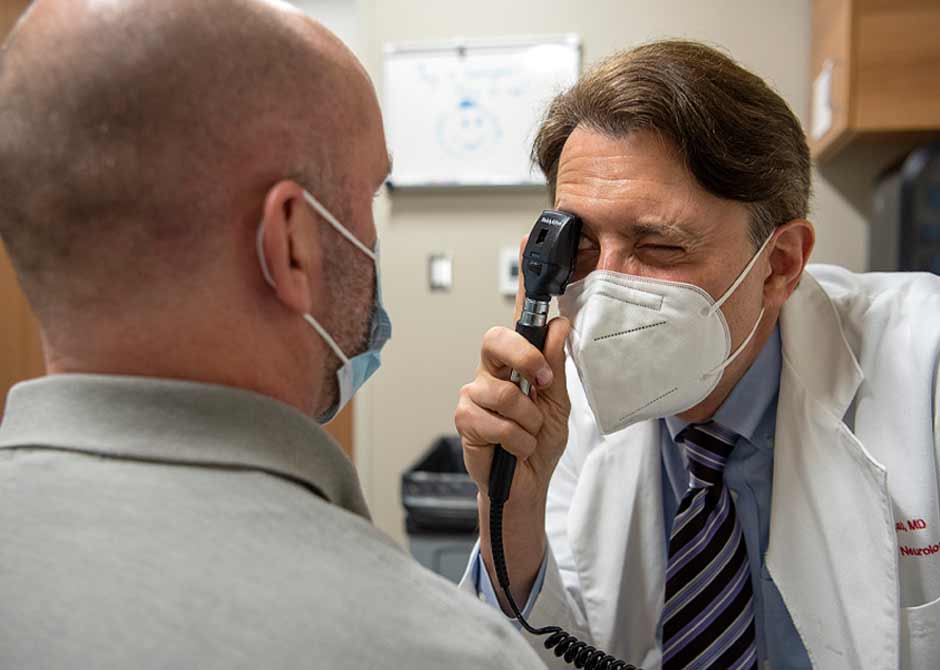 Dr. Segal and patient in exam wearing masks