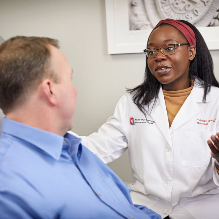 Multiple Sclerosis patient talking to doctor at clinic