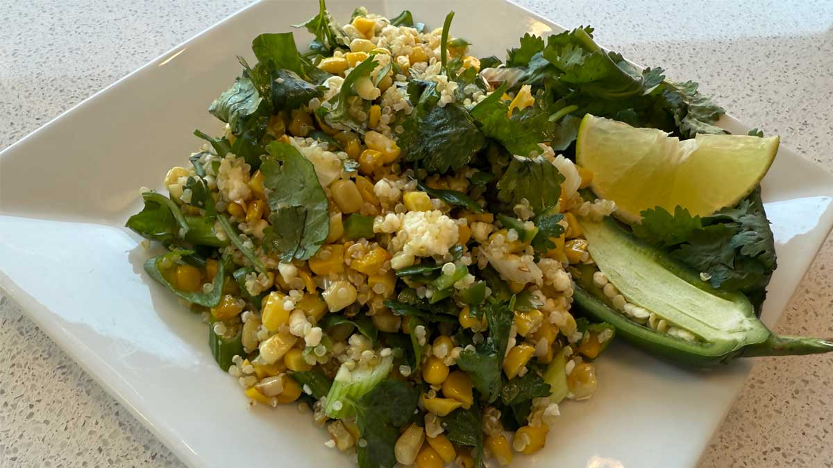 street corn salad on a plate with assorted garnish