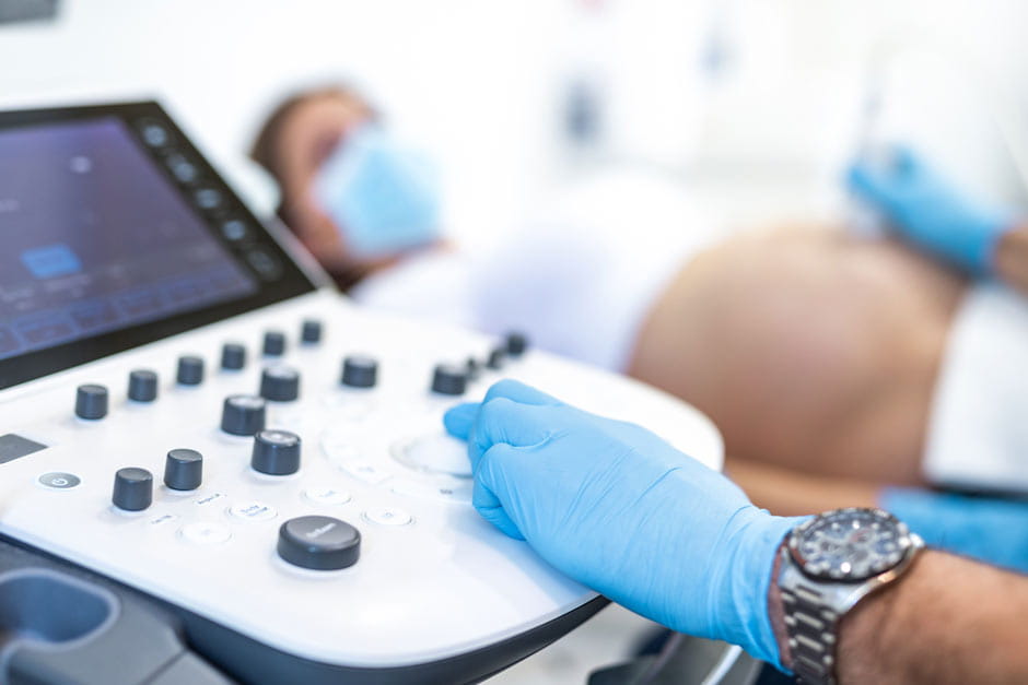 Sonographer touches ultrasound machine
